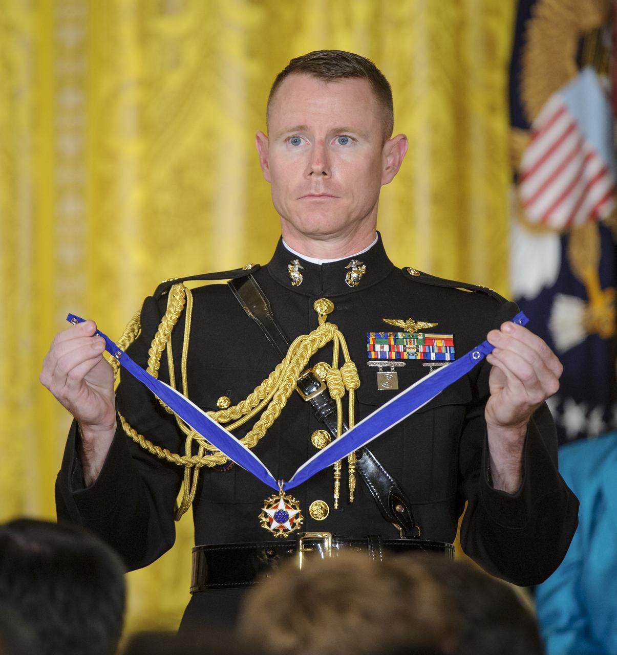 Major S. Lee Meyer, USMC, Military Aide to the President, holds the Presidential Medal of Freedom that is to be presented by President Barack Obama to former United States Marine Corps pilot, astronaut, and United States Senator John Glenn, Tuesday, May 29, 2012, during a ceremony at the White House in Washington. Photo Credit: (NASA/Bill Ingalls)