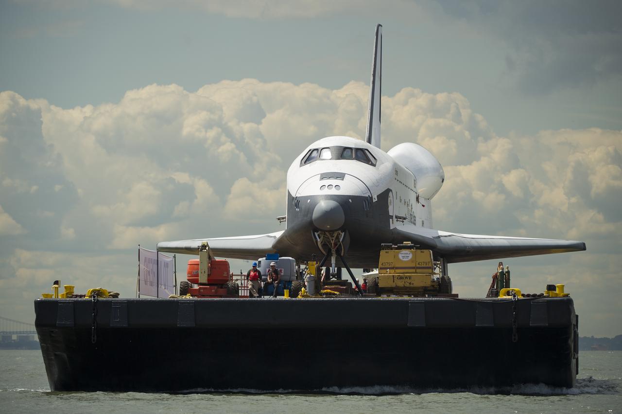 The space shuttle Enterprise is towed by barge up the Hudson River on it's way to the Intrepid Sea, Air and Space Museum where it will be permanently displayed, Wednesday, June 6, 2012 in New York City. Photo Credit: (NASA/Bill Ingalls)