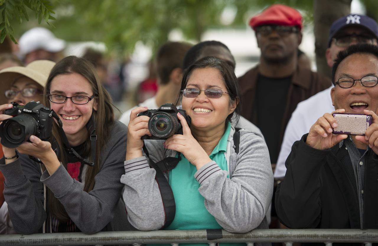 Large groups of spectators waited all day with their cameras in order to see the space shuttle Enterprise arrival on a barge and lift onto the Intrepid Sea, Air and Space Museum where it will be permanently displayed, Wednesday, June 6, 2012 in New York. Photo Credit: (NASA/Bill Ingalls)