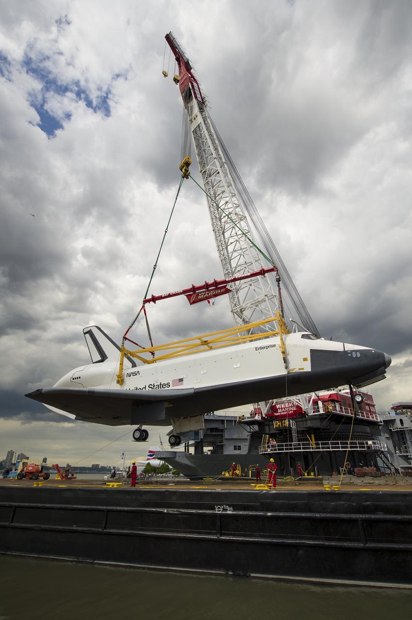 The space shuttle Enterprise is lifted off of a barge and onto the Intrepid Sea, Air and Space Museum where it will be on permanent displayed, Wednesday, June 6, 2012 in New York. Photo Credit: (NASA/Bill Ingalls)