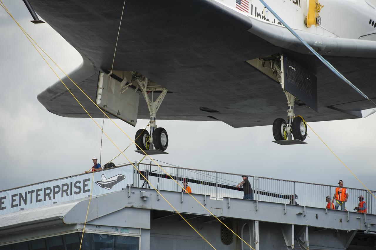 The space shuttle Enterprise is lifted off of a barge and onto the Intrepid Sea, Air and Space Museum where it will be on permanent displayed, Wednesday, June 6, 2012 in New York. Photo Credit: (NASA/Bill Ingalls)