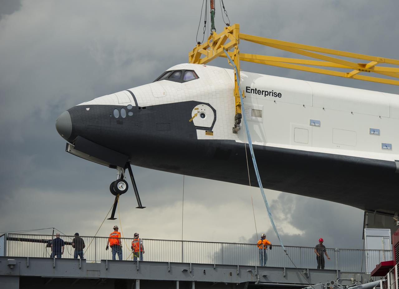 The space shuttle Enterprise is lifted off of a barge and onto the Intrepid Sea, Air and Space Museum where it will be on permanent displayed, Wednesday, June 6, 2012 in New York. Photo Credit: (NASA/Bill Ingalls)