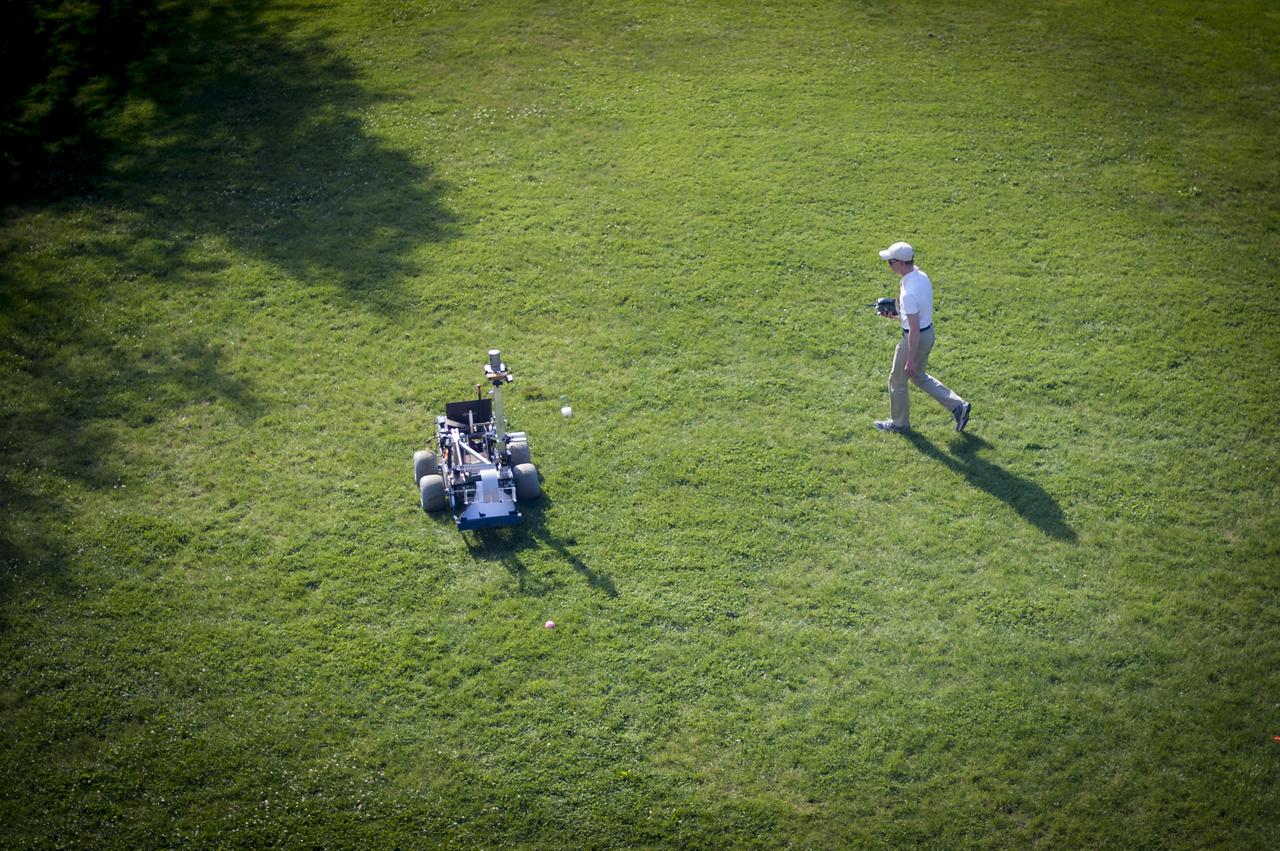 A University of Waterloo Robotics Team member tests their robot on the practice field two days prior to the NASA-WPI Sample Return Robot Centennial Challenge, Thursday, June 14, 2012 at the Worcester Polytechnic Institute in Worcester, Mass.  Teams will compete for a $1.5 million NASA prize to build an autonomous robot that can identify, collect and return samples.  NASA needs autonomous robotic capability for future planetary exploration. Photo Credit: (NASA/Bill Ingalls)