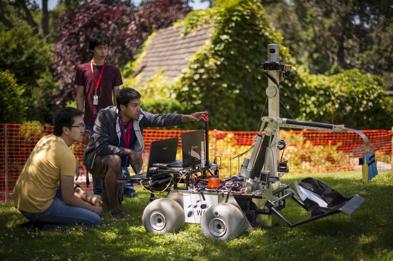University of Waterloo (Canada) Robotics Team members test their robot on the practice field one day prior to the NASA-WPI Sample Return Robot Centennial Challenge, Friday, June 15, 2012 at the Worcester Polytechnic Institute in Worcester, Mass.  Teams will compete for a $1.5 million NASA prize to build an autonomous robot that can identify, collect and return samples.  NASA needs autonomous robotic capability for future planetary exploration. Photo Credit: (NASA/Bill Ingalls)
