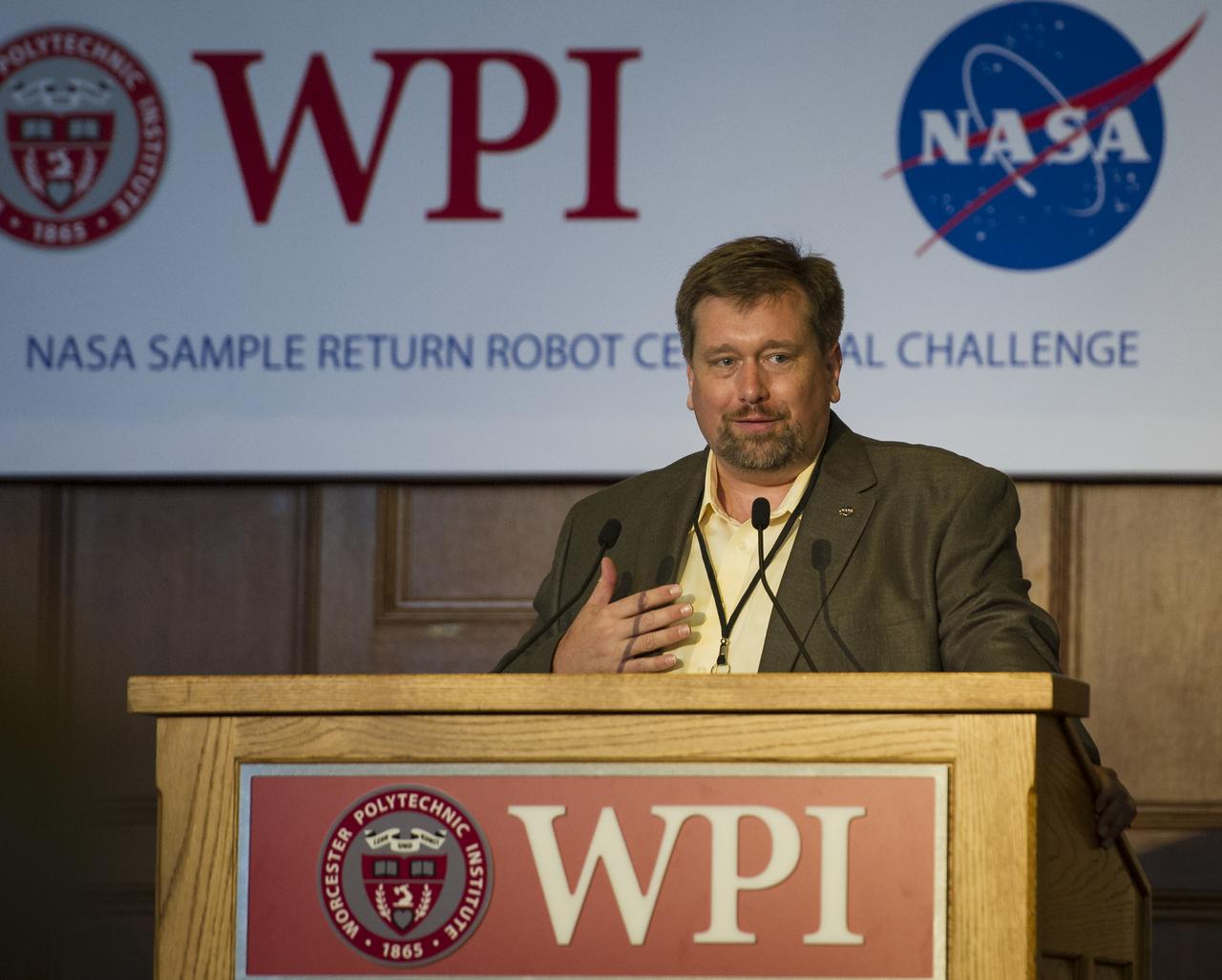 NASA Chief Technologist Mason Peck talks at the kick off of the NASA-WPI Sample Return Robot Centennial Challenge on Saturday, June 16, 2012 at the Worcester Polytechnic Institute (WPI) in Worcester, Mass. Teams were challenged to build autonomous robots that can identify, collect and return samples.  NASA needs autonomous robotic capability for future planetary exploration. Photo Credit: (NASA/Bill Ingalls)