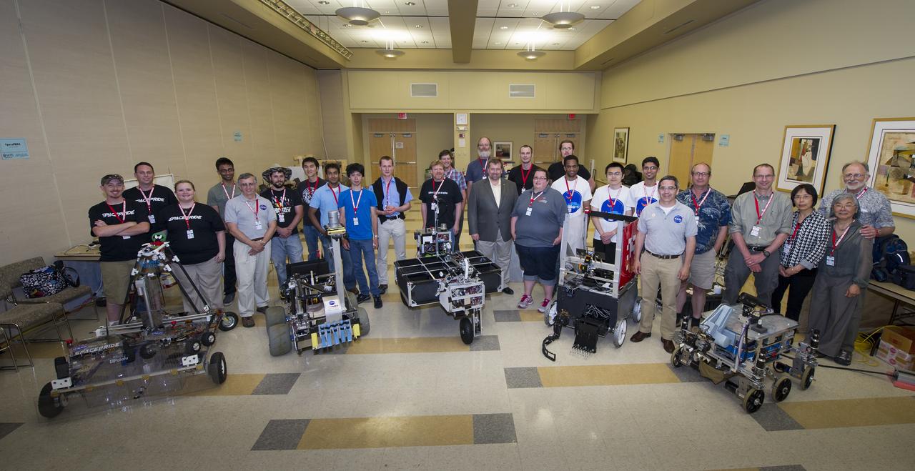 NASA-WPI Sample Return Robot Centennial Challenge teams, NASA management, and challenge organizers pose for a group photograph on Saturday, June 16, 2012 at Worcester Polytechnic Institute (WPI) in Worcester, Mass. Teams were challenged to build autonomous robots that can identify, collect and return samples.  NASA needs autonomous robotic capability for future planetary exploration. Photo Credit: (NASA/Bill Ingalls)