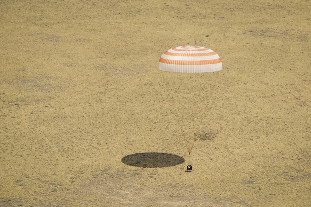 The Soyuz TMA-03M spacecraft is seen as it lands with Expedition 31 Commander Oleg Kononenko of Russia and Flight Engineers Don Pettit of NASA and Andre Kuipers of the European Space Agency in a remote area near the town of Zhezkazgan, Kazakhstan, on Sunday, July 1, 2012.  Pettit, Kononenko and Kuipers returned from more than six months onboard the International Space Station where they served as members of the Expedition 30 and 31 crews. Photo Credit: (NASA/Bill Ingalls)