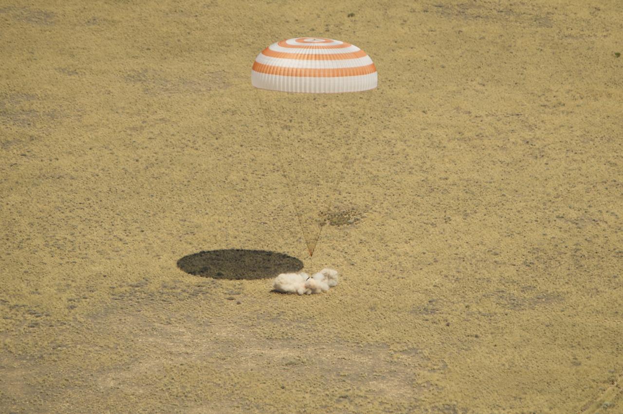 The Soyuz TMA-03M spacecraft is seen as it lands with Expedition 31 Commander Oleg Kononenko of Russia and Flight Engineers Don Pettit of NASA and Andre Kuipers of the European Space Agency in a remote area near the town of Zhezkazgan, Kazakhstan, on Sunday, July 1, 2012.  Pettit, Kononenko and Kuipers returned from more than six months onboard the International Space Station where they served as members of the Expedition 30 and 31 crews. Photo Credit: (NASA/Bill Ingalls)