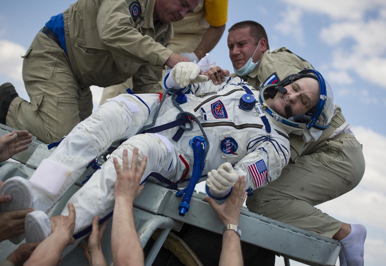 Support and medical personnel assist Expedition 31 Flight Engineer Don Pettit of NASA out of the Soyuz TMA-03M capsule shortly after he and Expedition 31 Commander Oleg Kononenko of Russia, and Flight Engineers Andre Kuipers of the European Space Agency landed in a remote area near the town of Zhezkazgan, Kazakhstan, on Sunday, July 1, 2012. Pettit, Kononenko and Kuipers returned from more than six months onboard the International Space Station where they served as members of the Expedition 30 and 31 crews. Photo Credit: (NASA/Bill Ingalls)