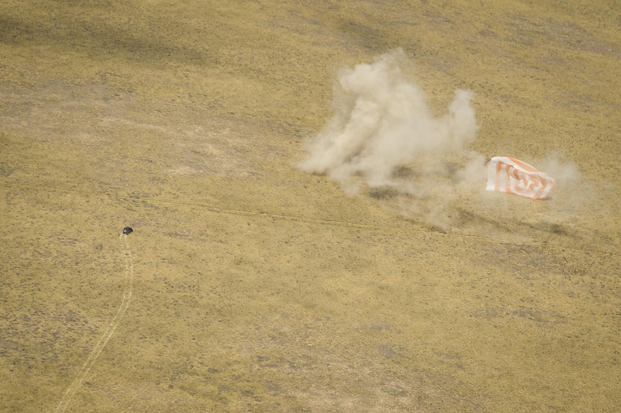 Support personnel rush to the the Soyuz TMA-03M capsule shortly after it landed with Expedition 31 Commander Oleg Kononenko of Russia and Flight Engineers Don Pettit of NASA and Andre Kuipers of the European Space Agency in a remote area near the town of Zhezkazgan, Kazakhstan, on Sunday, July 1, 2012. Pettit, Kononenko and Kuipers returned from more than six months onboard the International Space Station where they served as members of the Expedition 30 and 31 crews. Photo Credit: (NASA/Bill Ingalls)