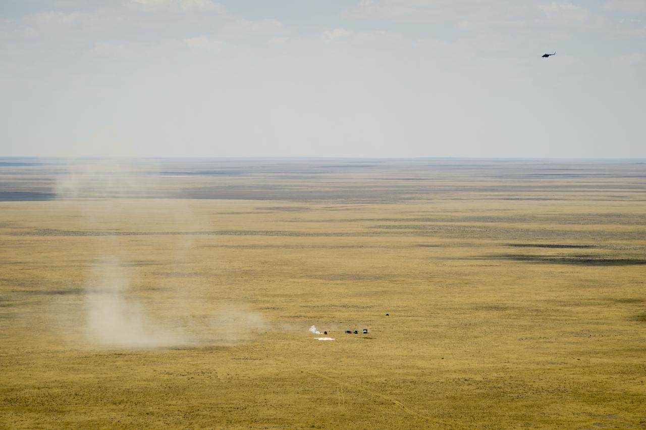 Support personnel rush to the the Soyuz TMA-03M capsule shortly after it landed with Expedition 31 Commander Oleg Kononenko of Russia and Flight Engineers Don Pettit of NASA and Andre Kuipers of the European Space Agency in a remote area near the town of Zhezkazgan, Kazakhstan, on Sunday, July 1, 2012. Pettit, Kononenko and Kuipers returned from more than six months onboard the International Space Station where they served as members of the Expedition 30 and 31 crews. Photo Credit: (NASA/Bill Ingalls)