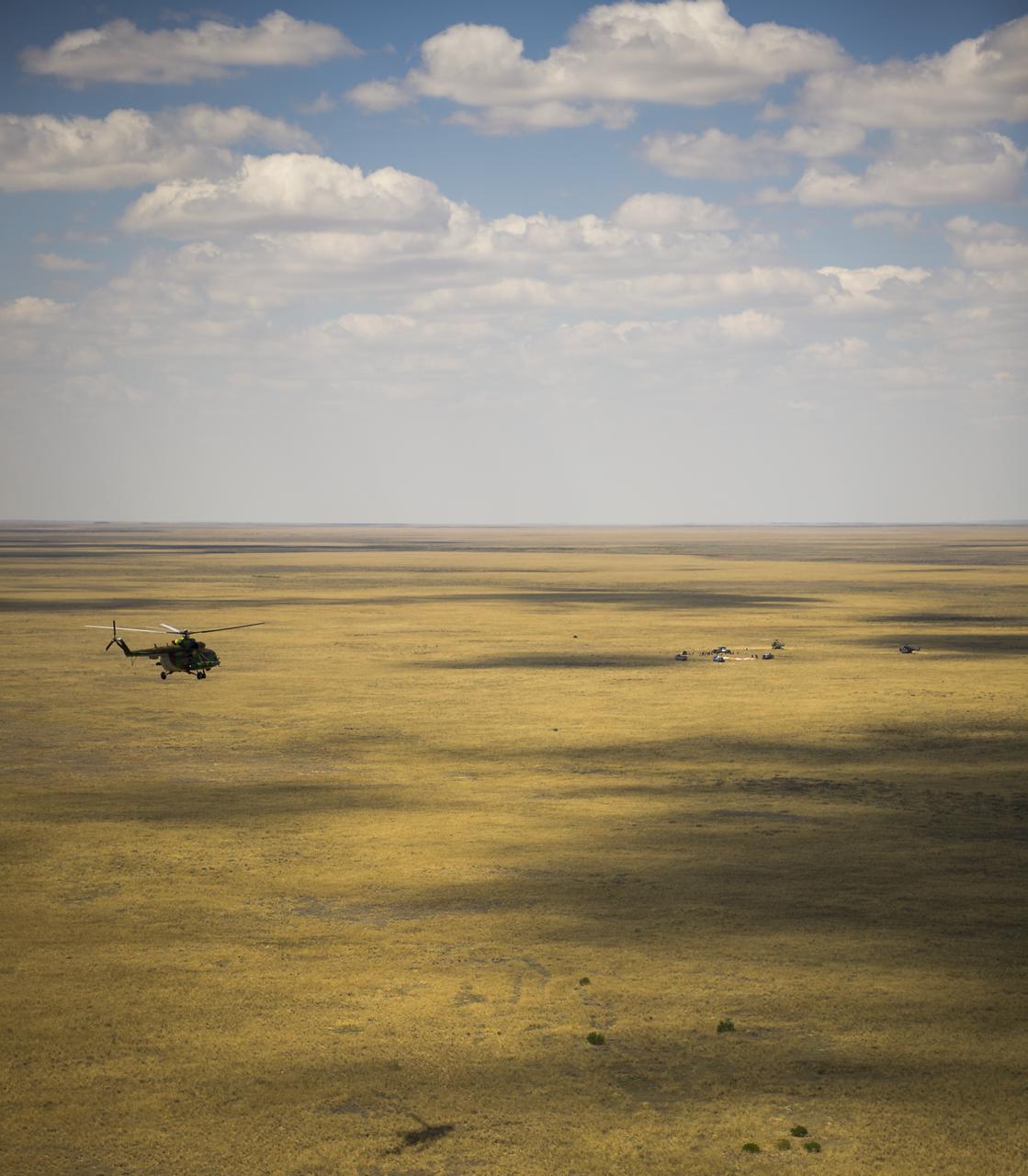 A Russian Search and Rescue helicopter flies to the the Soyuz TMA-03M capsule shortly after it landed with Expedition 31 Commander Oleg Kononenko of Russia and Flight Engineers Don Pettit of NASA and Andre Kuipers of the European Space Agency in a remote area near the town of Zhezkazgan, Kazakhstan, on Sunday, July 1, 2012. Pettit, Kononenko and Kuipers returned from more than six months onboard the International Space Station where they served as members of the Expedition 30 and 31 crews. Photo Credit: (NASA/Bill Ingalls)
