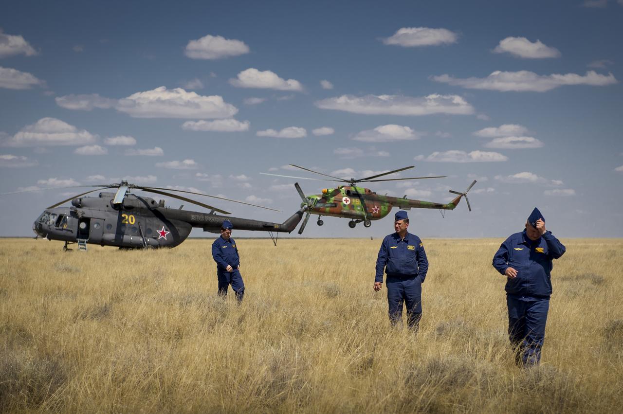 Additional Russian Search and Rescue crews arrive near the Soyuz TMA-03M capsule after it landed with Expedition 31 Commander Oleg Kononenko of Russia and Flight Engineers Don Pettit of NASA and Andre Kuipers of the European Space Agency in a remote area near the town of Zhezkazgan, Kazakhstan, on Sunday, July 1, 2012.  Pettit, Kononenko and Kuipers returned from more than six months onboard the International Space Station where they served as members of the Expedition 30 and 31 crews. Photo Credit: (NASA/Bill Ingalls)