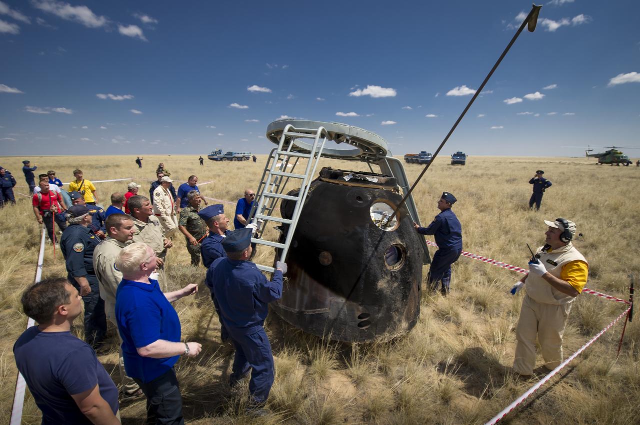 Russian Search and Rescue crews attach ladders and a slide for access to the Soyuz TMA-03M capsule shortly after it landed with Expedition 31 Commander Oleg Kononenko of Russia and Flight Engineers Don Pettit of NASA and Andre Kuipers of the European Space Agency in a remote area near the town of Zhezkazgan, Kazakhstan, on Sunday, July 1, 2012. Pettit, Kononenko and Kuipers returned from more than six months onboard the International Space Station where they served as members of the Expedition 30 and 31 crews. Photo Credit: (NASA/Bill Ingalls)