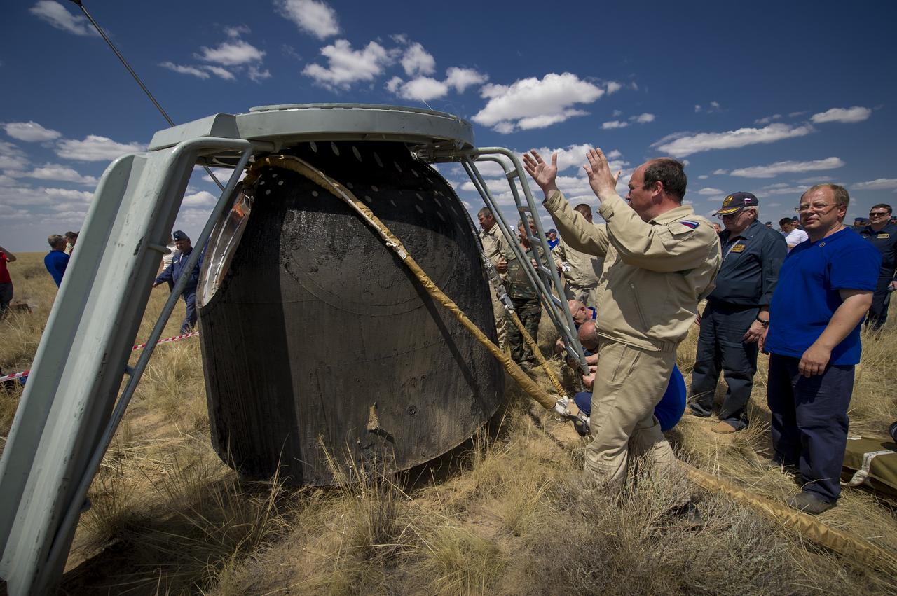 Russian support personnel prepare to access the crew of Soyuz TMA-03M capsule shortly after it landed with Expedition 31 Commander Oleg Kononenko of Russia and Flight Engineers Don Pettit of NASA and Andre Kuipers of the European Space Agency in a remote area near the town of Zhezkazgan, Kazakhstan, on Sunday, July 1, 2012. Pettit, Kononenko and Kuipers returned from more than six months onboard the International Space Station where they served as members of the Expedition 30 and 31 crews. Photo Credit: (NASA/Bill Ingalls)