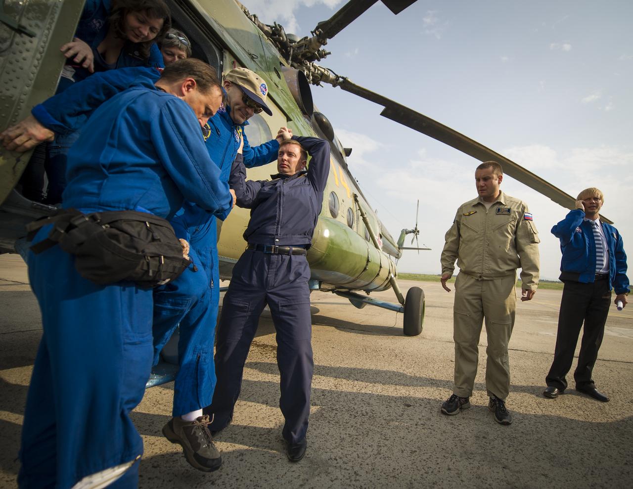 Expedition 31 Flight Engineer Don Pettit of NASA is helped out of a Russian Search and Rescue helicopter after it carried him from the Soyuz TMA-03M capsule landing site in a remote area near the town of Zhezkazgan to Karaganda on Sunday, July 1, 2012 in Kazakhstan. Expedition 31 Commander Oleg Kononenko of Russia and Flight Engineers Pettit and Andre Kuipers of the European Space Agency landed in their Soyuz TMA-03M capsule in a remote area near the town of Zhezkazgan, Kazakhstan after serving more than six months onboard the International Space Station as members of the Expedition 30 and 31 crews. Photo Credit: (NASA/Bill Ingalls)