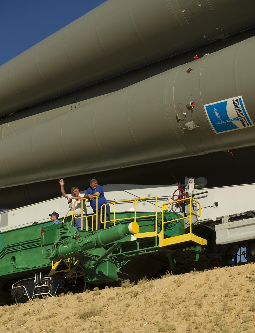 A russian space engineer waves hello as the Soyuz TMA-05M is rolled to its launch pad at the Baikonur Cosmodrome in Kazakhstan, Thursday, July 12, 2012. The launch of the Soyuz spacecraft with Expedition 32 Soyuz Commander Yuri Malenchenko, NASA Flight Engineer Sunita Williams and JAXA (Japan Aerospace Exploration Agency) Flight Engineer Akihiko Hoshide is scheduled for the morning of Sunday, July 15, local time. Photo Credit (NASA/Carla Cioffi)