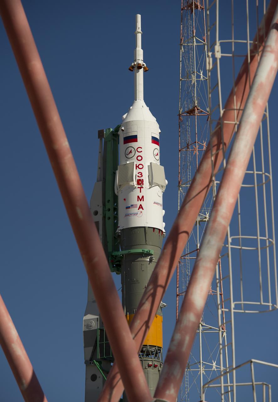 The Soyuz TMA-05M spacecraft is seen through a radio tower structure following its arrival at its launch pad, Thursday, July 12, 2012 at the Baikonur Cosmodrome in Kazakhstan. The launch of the Soyuz rocket is scheduled for the morning of July 15 local time. Photo Credit: (NASA/Carla Cioffi)