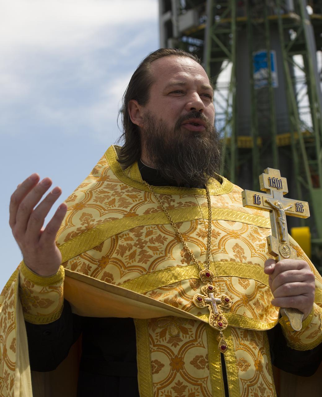 An Orthodox priest talks to members of the press just after having blessed the Soyuz rocket at the Baikonur Cosmodrome Launch pad on Friday, July 13, 2012 in Kazakhstan. The launch of the Soyuz spacecraft with Expedition 32 Soyuz Commander Yuri Malenchenko, NASA Flight Engineer Sunita Williams and JAXA (Japan Aerospace Exploration Agency) Flight Engineer Akihiko Hoshide is scheduled for the morning of Sunday, July 15, local time. Photo Credit: (NASA/Carla Cioffi)