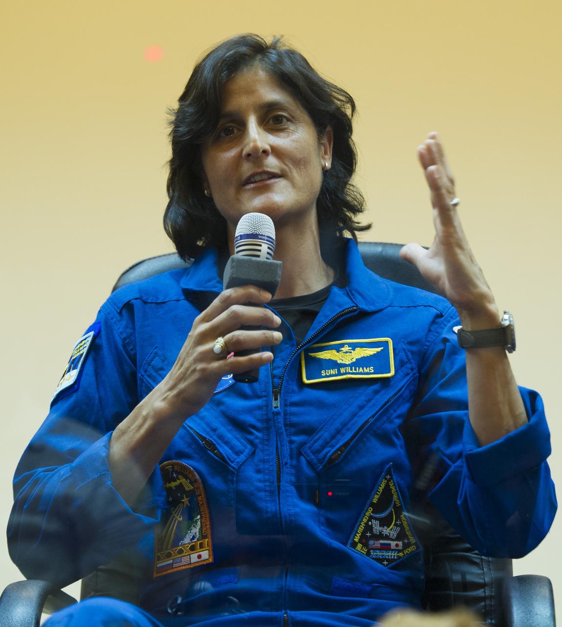 Quarantined Expedition 32 Flight Engineer Sunita Williams answers reporters questions from behind glass during a prelaunch press conference held at the Cosmonaut Hotel on Friday, July 13, 2012 in Baikonur, Kazakhstan.  The launch of the Soyuz spacecraft with Williams, Soyuz Commander Yuri Malenchenko, and JAXA Flight Engineer Akihiko Hoshide is scheduled for 8:40 a.m. local time on Sunday, July 15.  Photo Credit (NASA/Carla Cioffi)