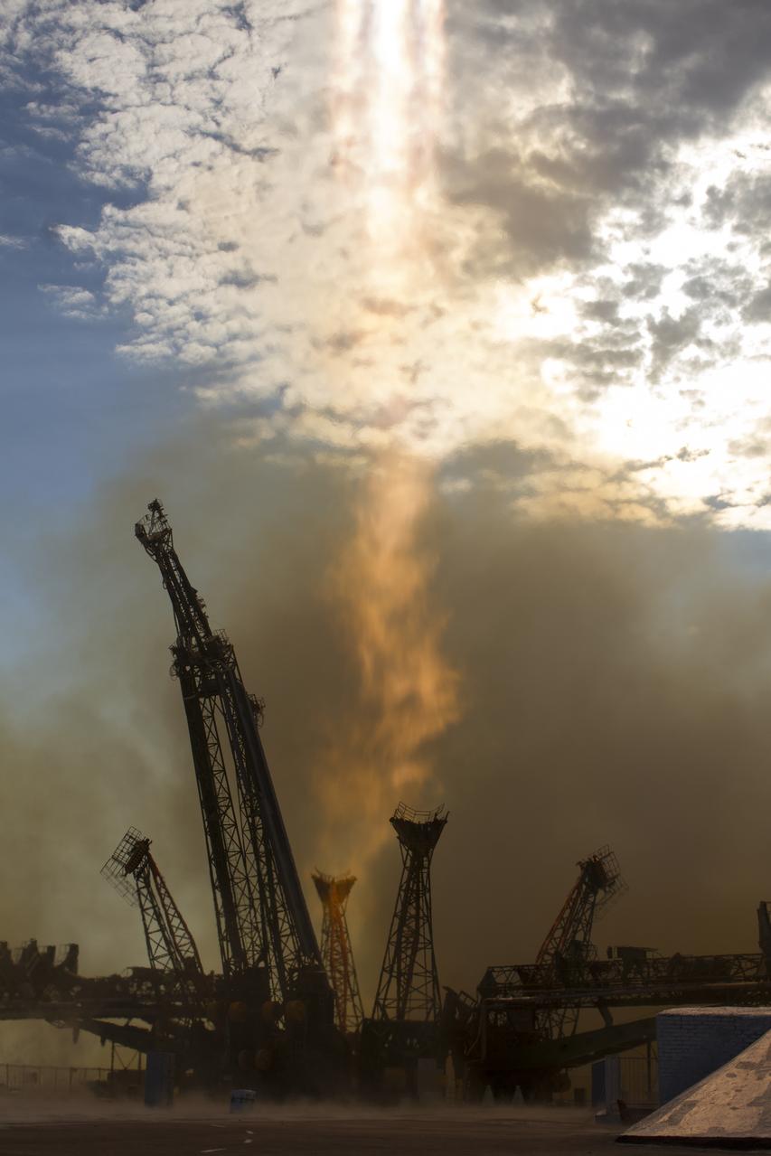 The tail end of the flame from the Soyuz TMA-05M rocket is seen after it launched from the Baikonur Cosmodrome in Kazakhstan on Sunday, July 15, 2012 carrying Expedition 32 Soyuz Commander Yuri Malenchenko, NASA Flight Engineer Sunita Williams and JAXA (Japan Aerospace Exploration Agency) Flight Engineer Akihiko Hoshide to the International Space Station.  Photo Credit: (NASA/Carla Cioffi)