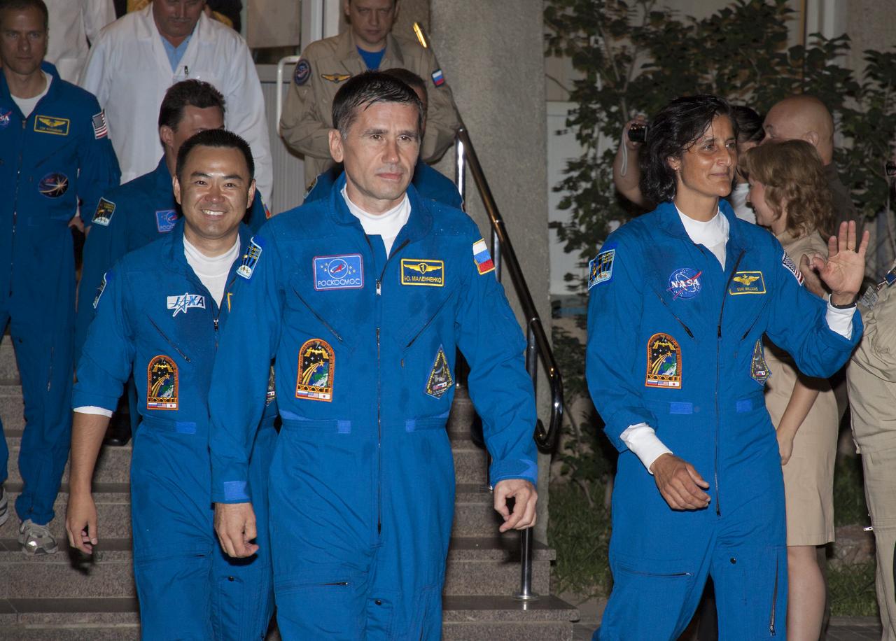 Expedition 32 crew members JAXA astronaut Akihiko Hoshide, left, Soyuz Commander Yuri Malenchenko and NASA astronaut Sunita Williams, right, wave farewell as they depart the Cosmonaut Hotel on Sunday, July 15, 2012 in Baikonur, Kazakhstan. The Soyuz spacecraft with Malenchenko, Williams and Hoshide onboard launched at 8:40 a.m. later that morning Kazakhstan time. Photo Credit: (NASA/Victor Zelentsov)