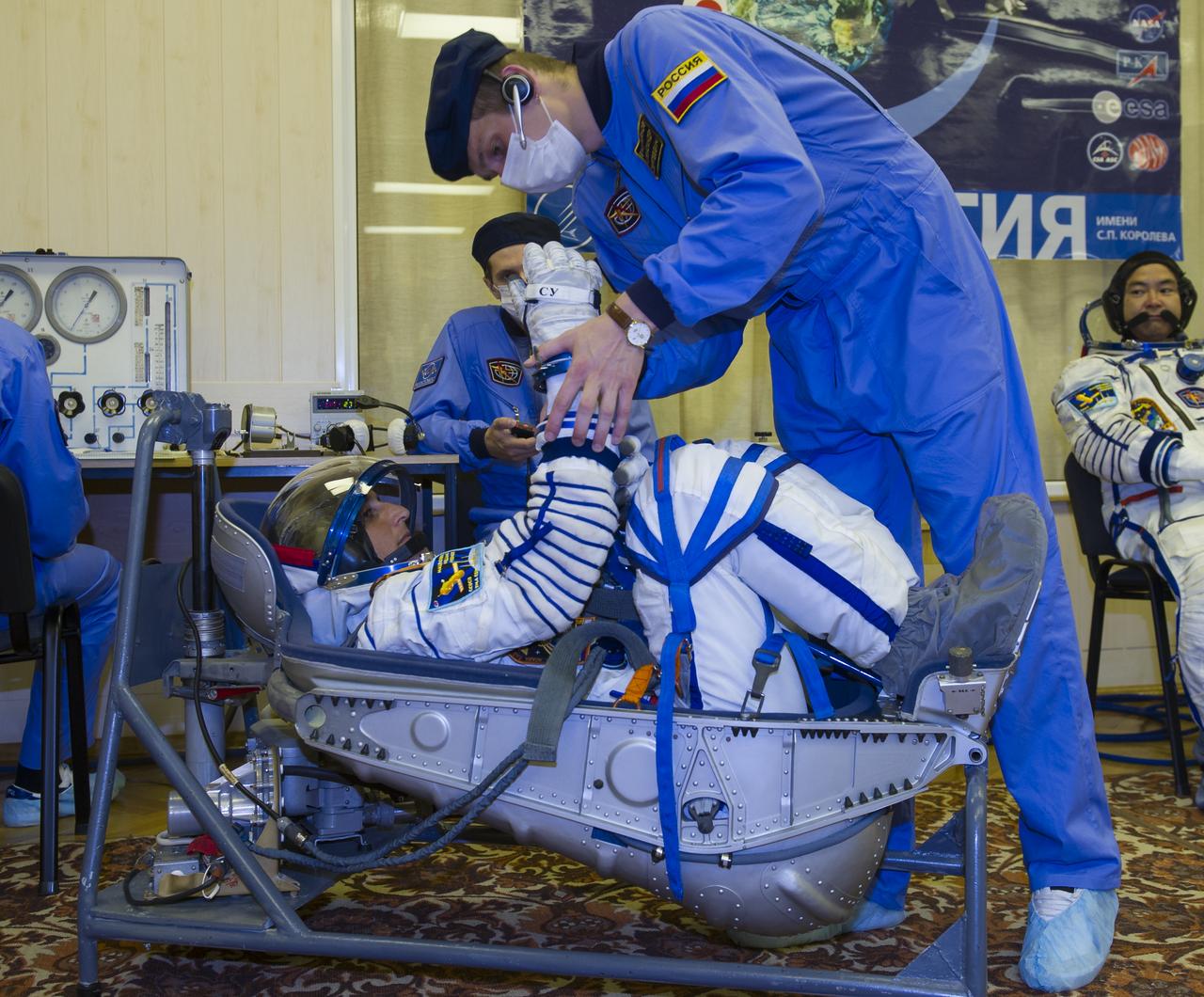 Expedition 32 NASA Flight Engineer Sunita Williams lies in a chair to have her Russian Sokol suit pressure checked in preparation for his launch onboard the Soyuz TMA-05M on Sunday, July 15, 2012 at the Baikonur Cosmodrome in Kazakhstan. The launch of the Soyuz spacecraft with Williams, Soyuz Commander Yuri Malenchenko and JAXA Flight Engineer Akihiko Hoshide is scheduled for the morning of Sunday, July 15, local time.  Photo Credit: (NASA/GCTC/Irina Peshkova)