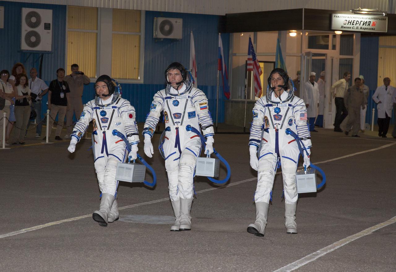 Expedition 32 Flight Engineer Sunita Williams, right, Soyuz Commander Yuri Malenchenko and JAXA Flight Engineer Akihiko Hoshide, left, leave building 254 following their suit up for launch Sunday, July 15, 2012 at the Baikonur Cosmodrome in Kazakhstan. The Soyuz spacecraft with Malenchenko, Williams and Hoshide onboard launched at 8:40 a.m. later that morning Kazakhstan time. Photo Credit: (NASA/Victor Zelentsov)