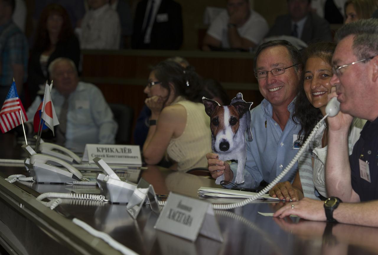 Expedition 32 Flight Engineer Sunita Williams’ sister and friend brought a photo of William’s dog “Gorby” in support of her arrival to the International Space Station on Tuesday, July 17, 2012 at the Russian Mission Control Center in Korolev, Russia. The Soyuz docked to the International Space Station with Williams and fellow crew members Soyuz Commander Yuri Malenchenko and JAXA Flight Engineer Akihiko Hoshide two days after they launched from the Baikonur Cosmodrome in Kazakhstan.  Photo Credit: (NASA/Carla Cioffi)