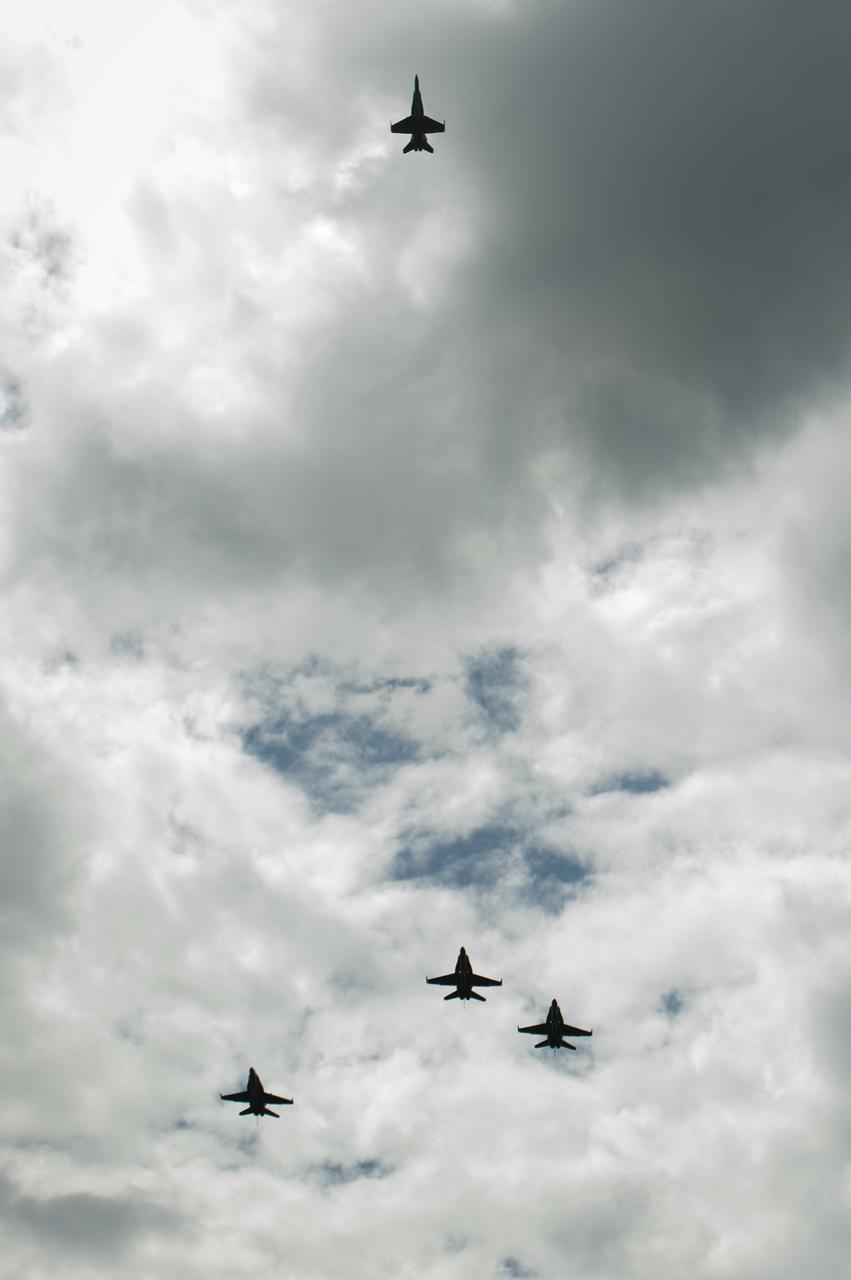U.S. Navy F/A-18 jets from Strike Fighter Squadron (VFA) 106 and Strike Fighter Squadron (VFA) 34, from Naval Air Station Oceana (Va.) fly in a "Missing Man" formation over the Camargo Club following a memorial service celebrating the life of Neil Armstrong, Friday, Aug. 31, 2012, in Cincinnati. Armstrong, the first man to walk on the moon during the 1969 Apollo 11 mission, died Saturday, Aug. 25. He was 82. Photo Credit: (NASA/Bill Ingalls)