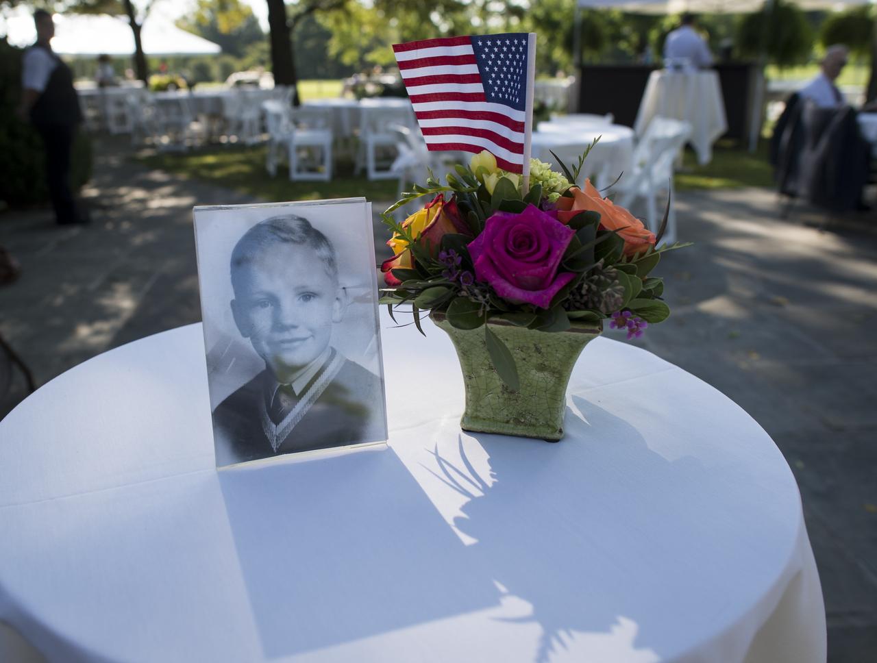A photograph of Neil Armstrong as a young man is displayed on a table during a memorial service celebrating the life of Armstrong, Friday, Aug. 31, 2012, at the Camargo Club in Cincinnati. Armstrong, the first man to walk on the moon during the 1969 Apollo 11 mission, died Saturday, Aug. 25. He was 82. Photo Credit: (NASA/Bill Ingalls)