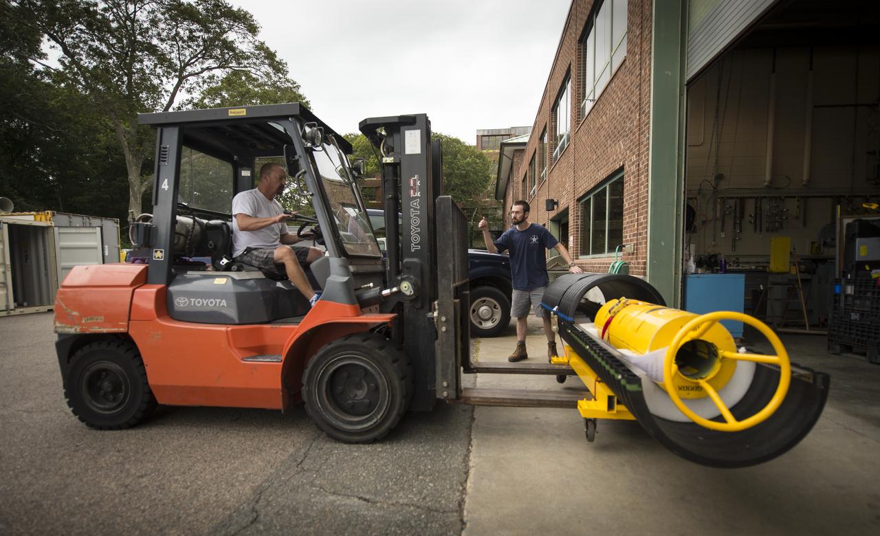 Chip Beniot, left, and Ken Decoteau, both of the Woods Hole Oceanographic Institution, move scientific instruments to the research vessel Knorr on Tuesday, Sept. 4, 2012, in Woods Hole, Mass. The instruments will be deployed in the Atlantic Ocean as part of the Salinity Processes in the Upper Ocean Regional Study (SPURS) which is set to sail on Sept. 6. The NASA-sponsored expedition will sail to the North Atlantic's saltiest spot to get a detailed, 3-D picture of how salt content fluctuates in the ocean's upper layers and how these variations are related to shifts in rainfall patterns around the planet. Photo Credit: (NASA/Bill Ingalls)