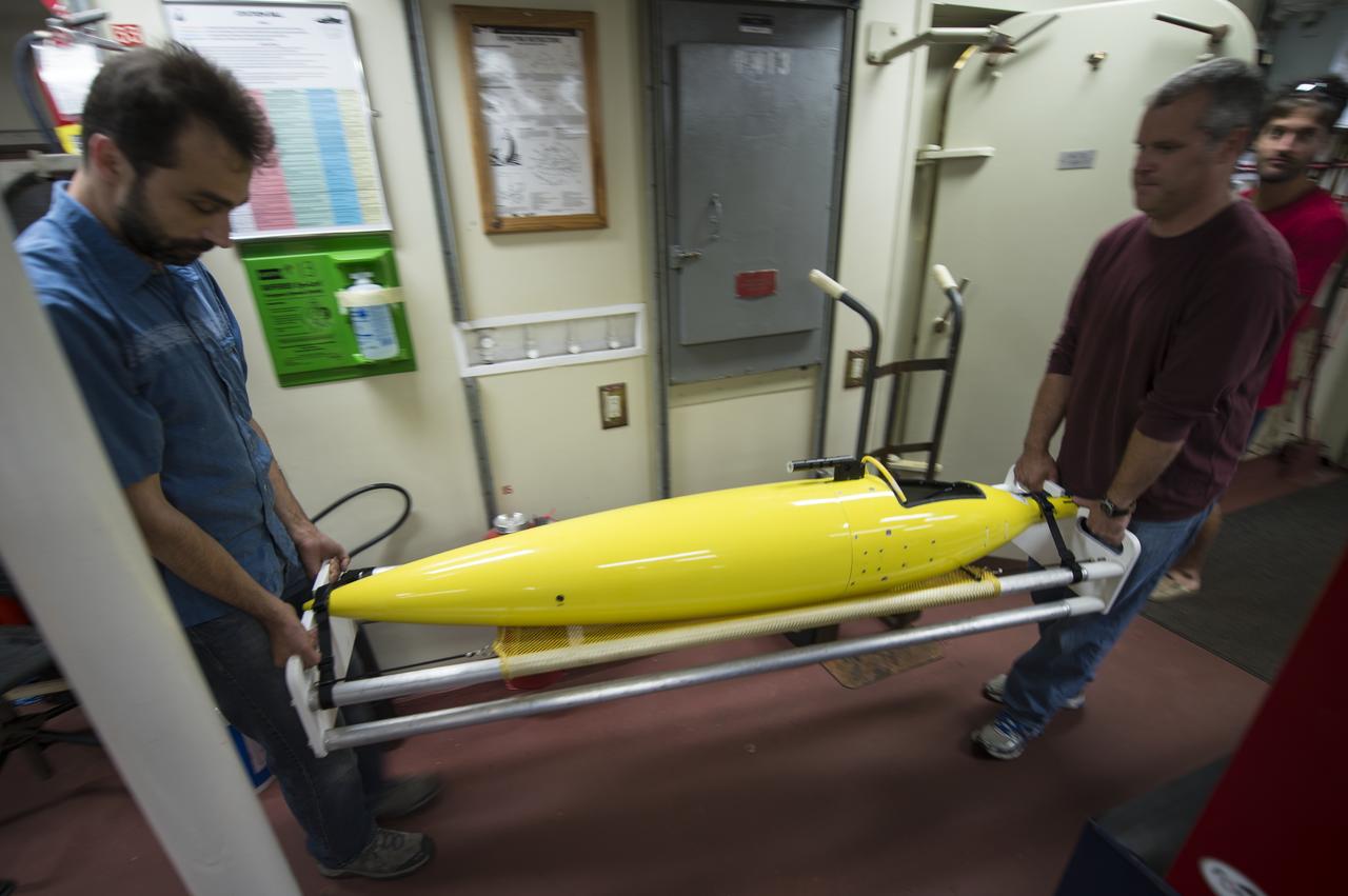 University of Washington Applied Physics Laboratory Senior Oceanographer Andrey Shcherbina, left, and University of Washington Applied Physics Laboratory Senior Principal Oceanographer Jason Gobat carry one of their instruments onboard the Woods Hole Oceanographic Institution's research vessel Knorr on Tuesday, Sept. 4, 2012, in Woods Hole, Mass.  Knorr is scheduled to depart on Sept. 6 to take part in the Salinity Processes in the Upper Ocean Regional Study (SPURS).  The NASA-sponsored expedition will sail to the North Atlantic's saltiest spot to get a detailed, 3-D picture of how salt content fluctuates in the ocean's upper layers and how these variations are related to shifts in rainfall patterns around the planet.  Photo Credit: (NASA/Bill Ingalls)