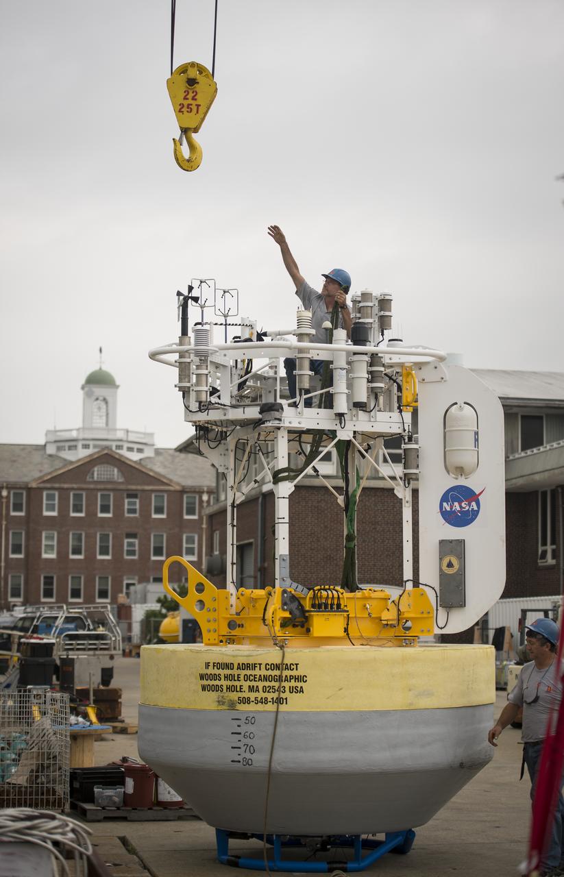 An worker prepares to attached a crane hook onto a sensor-laden buoy so that it may be loaded onboard the Woods Hole Oceanographic Institution's research vessel Knorr on wednesday, Sept. 5, 2012, in Woods Hole, Mass. The buoy will be deployed in the Atlantic Ocean as part of the Salinity Processes in the Upper Ocean Regional Study (SPURS) which is set to sail on Sept. 6. The NASA-sponsored expedition will sail to the North Atlantic's saltiest spot to get a detailed, 3-D picture of how salt content fluctuates in the ocean's upper layers and how these variations are related to shifts in rainfall patterns around the planet. Photo Credit: (NASA/Bill Ingalls)