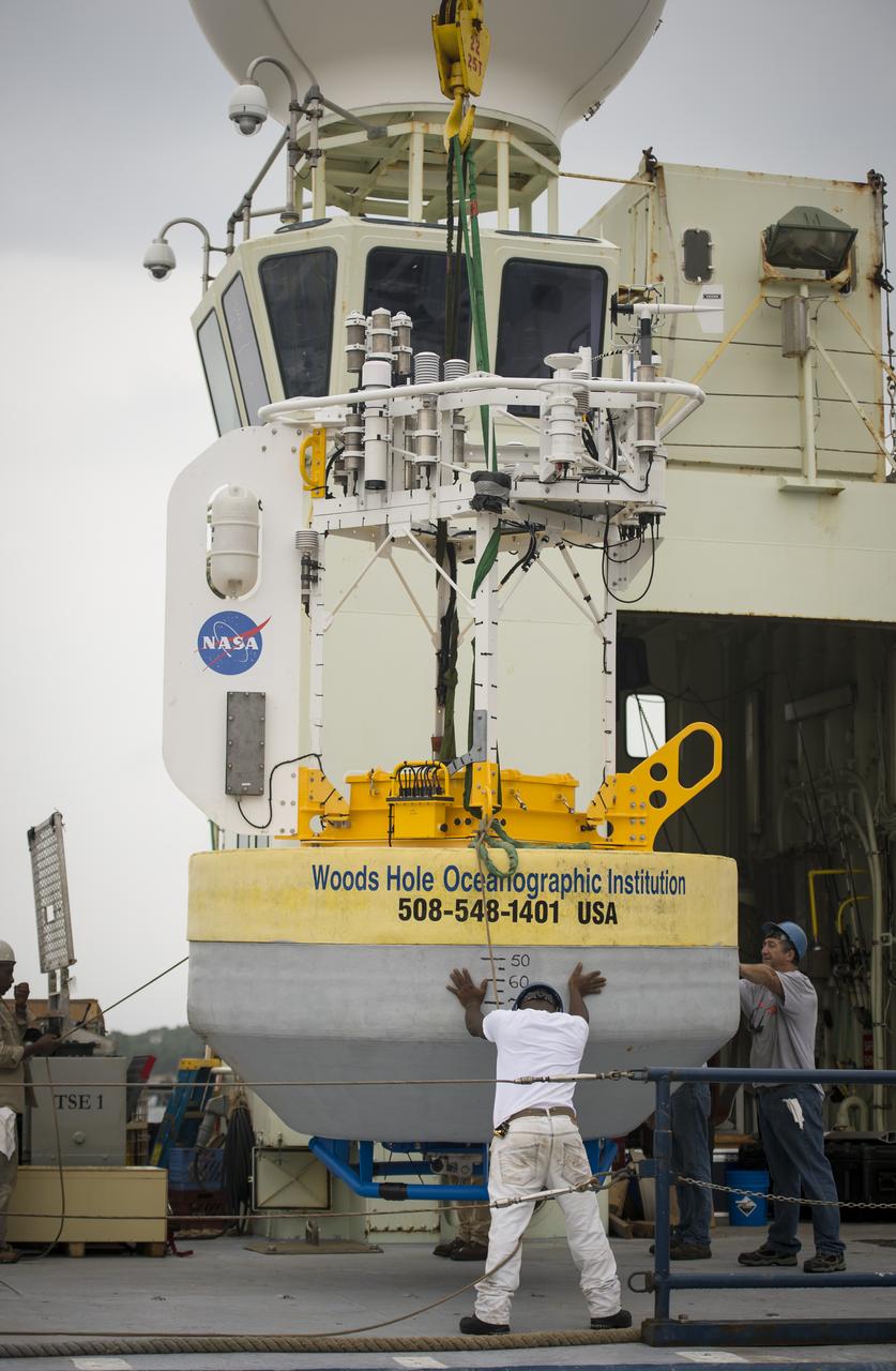 A sensor-laden buoy is lifted onboard the Woods Hole Oceanographic Institution's research vessel Knorr on wednesday, Sept. 5, 2012, in Woods Hole, Mass. The buoy will be deployed in the Atlantic Ocean as part of the Salinity Processes in the Upper Ocean Regional Study (SPURS) which is set to sail on Sept. 6. The NASA-sponsored expedition will sail to the North Atlantic's saltiest spot to get a detailed, 3-D picture of how salt content fluctuates in the ocean's upper layers and how these variations are related to shifts in rainfall patterns around the planet. Photo Credit: (NASA/Bill Ingalls)