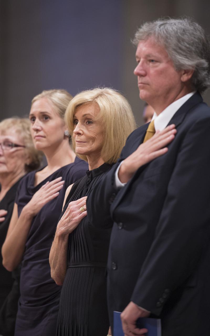 Carol Armstrong, center, her son Eric, right, and daughter Molly Van Wagenen hold their hands to their hearts during a memorial service celebrating the life of Neil Armstrong at the Washington National Cathedral, Thursday, Sept. 13, 2012. Armstrong, the first man to walk on the moon during the 1969 Apollo 11 mission, died Saturday, Aug. 25. He was 82. Photo Credit: (NASA/Bill Ingalls)