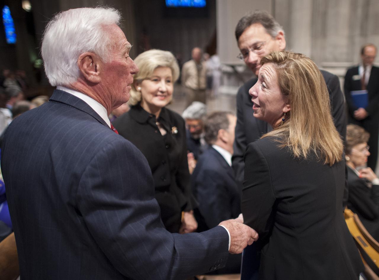 NASA Deputy Administrator Lori Garver, right, shares a moment with Apollo 17 mission commander Gene Cernan, the last man to walk on the moon, left, as U.S. Sen. Kay Bailey Hutchison, R-Texas, center looks on prior to a memorial service celebrating the life of Neil Armstrong, Thursday, Sept. 13, 2012, at the Washington National Cathedral. Armstrong, the first man to walk on the moon during the 1969 Apollo 11 mission, died Saturday, Aug. 25. He was 82. Photo Credit: (NASA/Bill Ingalls)