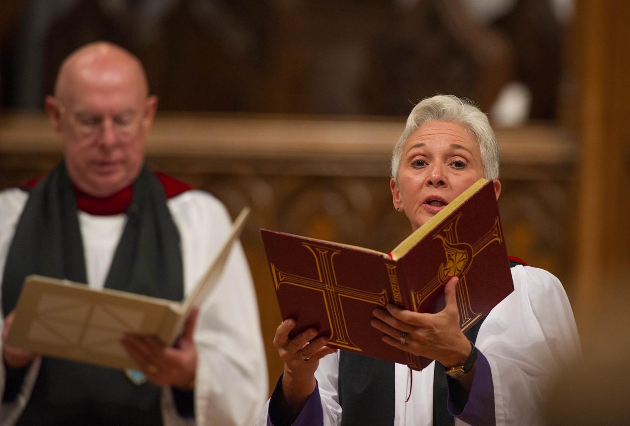 The Rev. Gina Gilland Campbell, acting director of worship, Washington National Cathedral, reads the Gospel during a memorial service celebrating the life of Neil Armstrong at the Washington National Cathedral, Thursday, Sept. 13, 2012. Armstrong, the first man to walk on the moon during the 1969 Apollo 11 mission, died Saturday, Aug. 25. He was 82. Photo Credit: (NASA/Paul E. Alers)