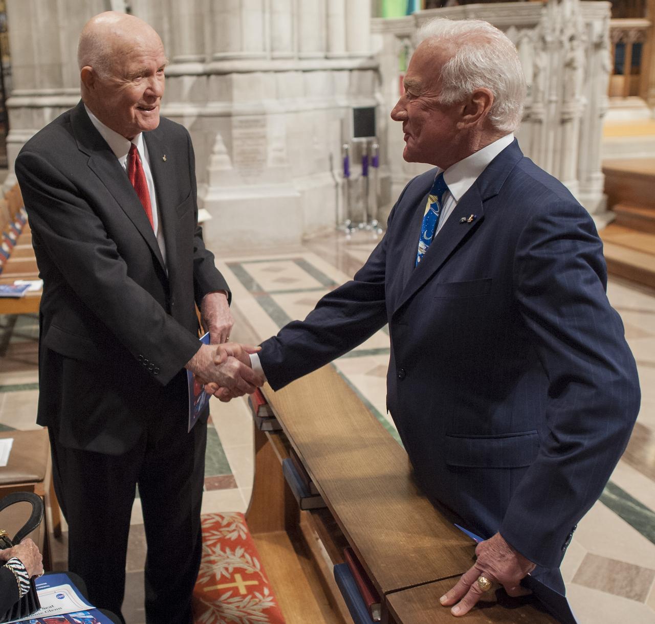 Former U.S. Sen. John Glenn, left, and Buzz Aldrin shake hands prior to a memorial service celebrating the life of Neil Armstrong, Thursday, Sept. 13, 2012, at the Washington National Cathedral. Armstrong, the first man to walk on the moon during the 1969 Apollo 11 mission, died Saturday, Aug. 25. He was 82. Photo Credit: (NASA/Bill Ingalls)