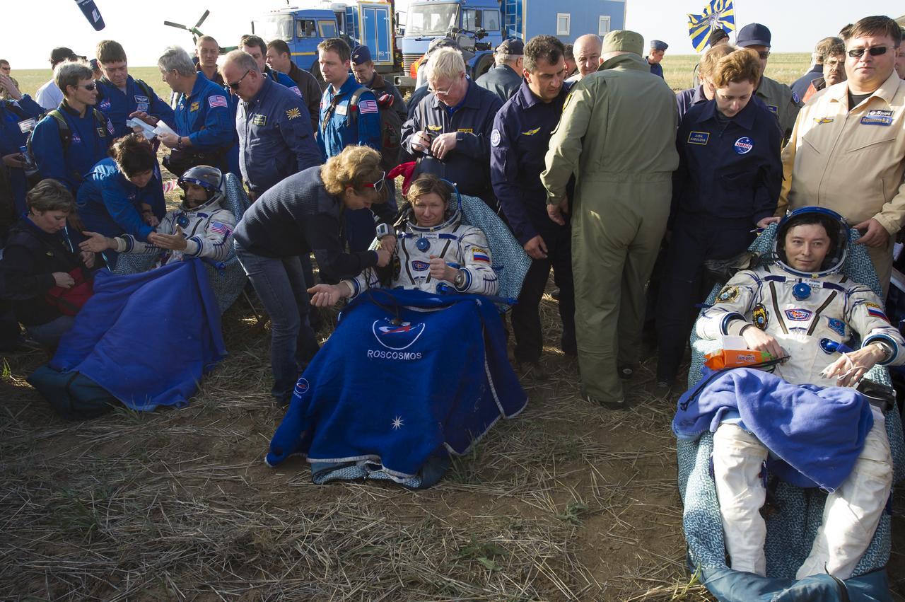Expedition 32 NASA Flight Engineer Joe Acaba, left, Expedition 32 Commander Gennady Padalka, center, and Flight Engineer Sergei Revin sit in chairs outside the Soyuz Capsule just minutes after they landed in a remote area outside the town of Arkalyk, Kazakhstan, on Monday, Sept. 17, 2012. Acaba, Padalka and Revin are returning from five months onboard the International Space Station where they served as members of the Expedition 31 and 32 crews. Photo Credit: (NASA/Carla Cioffi)