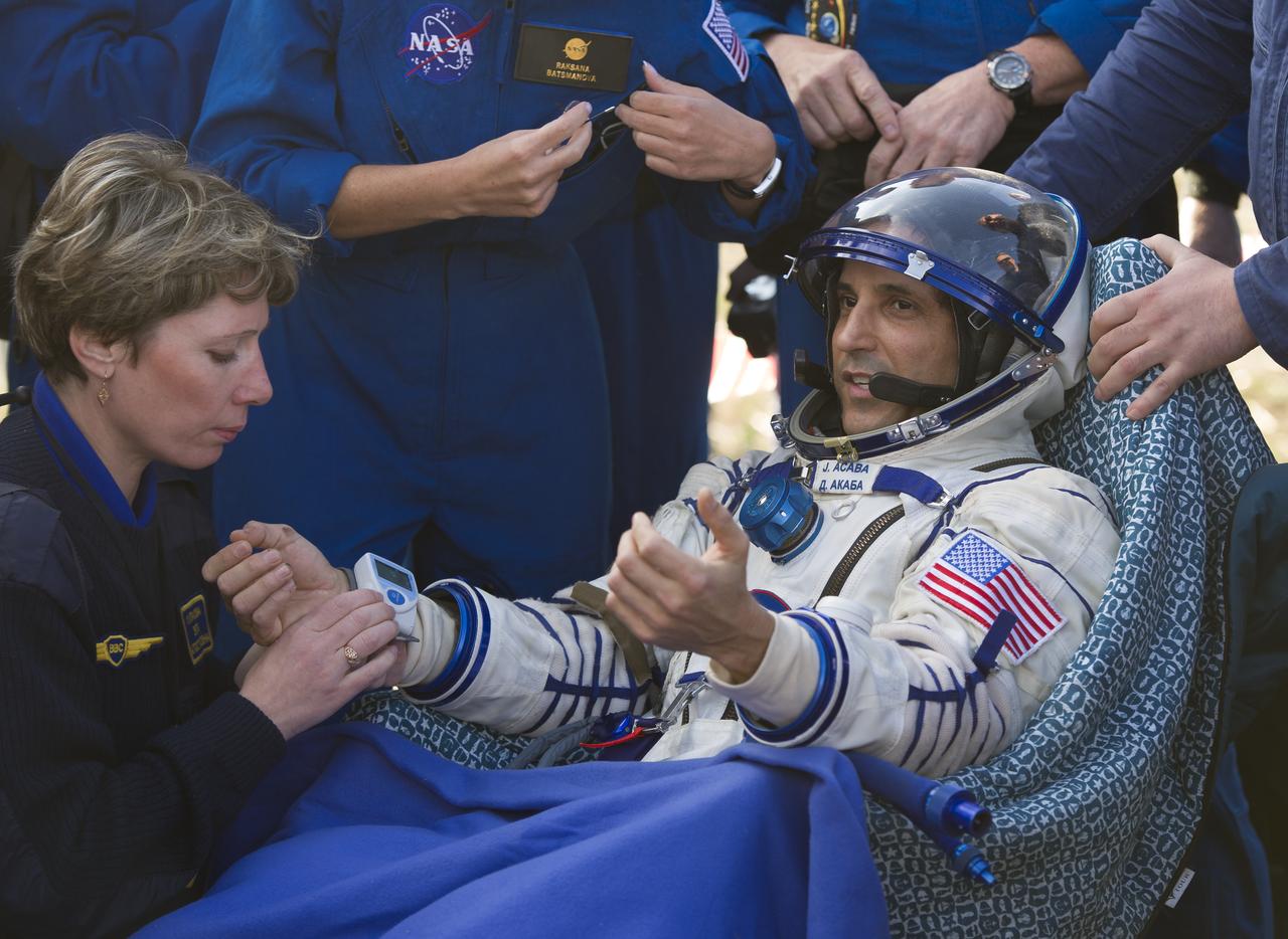 Expedition 32 NASA Flight Engineer Joe Acaba is attended to by crew support personnel following his landing in the Soyuz TMA-04M spacecraft, Monday, Sept. 17, 2012.  Acaba and Russian cosmonauts Padalka and Revin are returning from five months onboard the International Space Station where they served as members of the Expedition 31 and 32 crews.  Photo Credit: (NASA/Carla Cioffi)