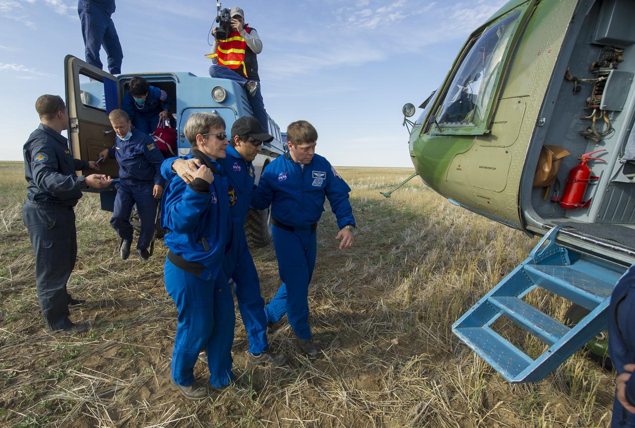 Expedition 32 NASA Flight Engineer Joe Acaba is helped from a Russian Search and Rescue all terrain vehicle (ATV) to his helicopter after he and Expedition 32 Commander Gennady Padalka and Flight Engineer Sergei Revin returned from the International Space Station on Monday, Sept. 17, 2012.  Acaba, Padalka and Revin returned from five months onboard the International Space Station where they served as members of the Expedition 31 and 32 crews.  Photo Credit: (NASA/Carla Cioffi)