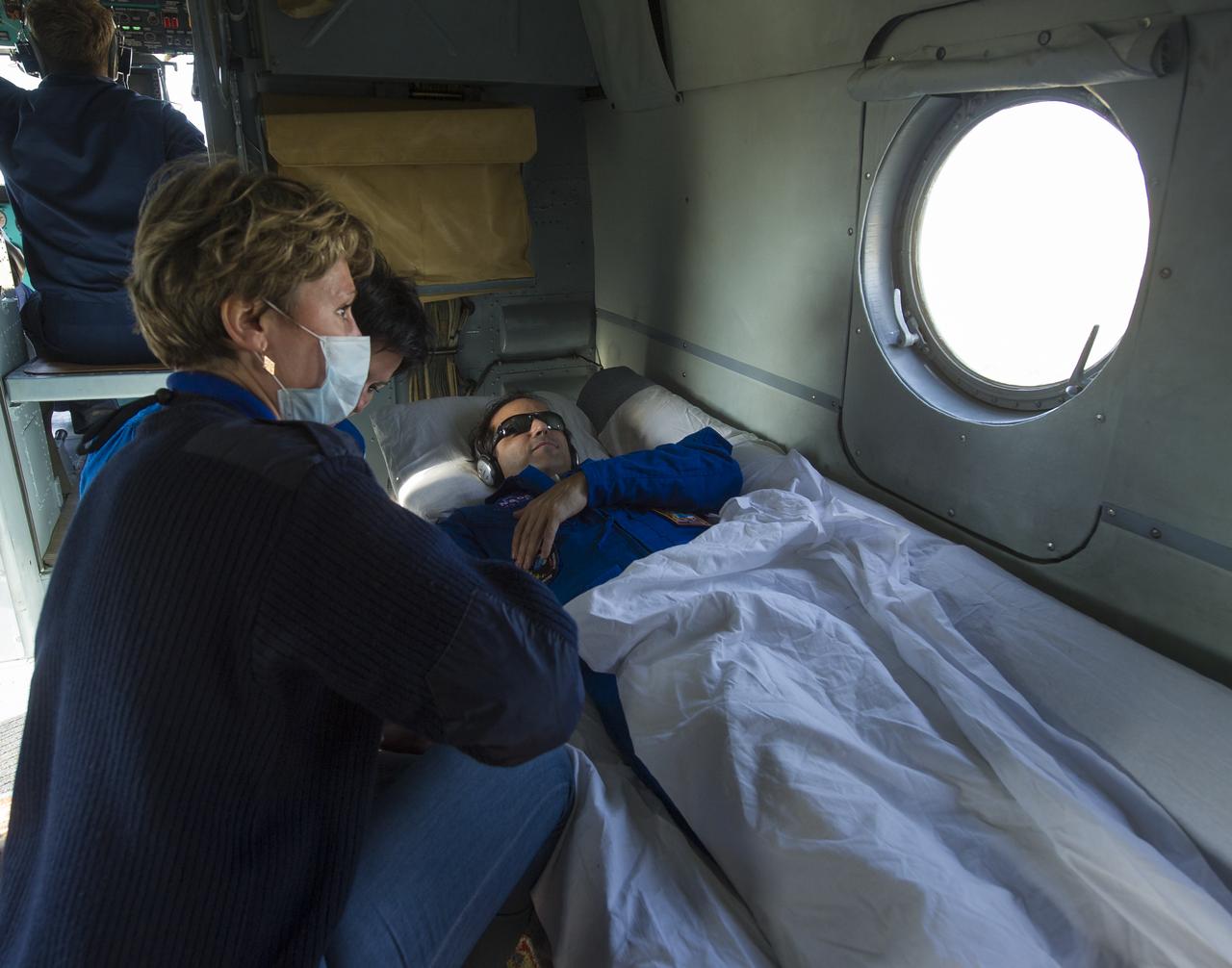 Expedition 32 NASA Flight Engineer Joe Acaba rests on the Russian Search and Rescue helicopter that is carrying him from the Soyuz TMA-04M landing site in a remote area outside Arkalyk, Kazakhstan to Kostanay, Kazakhstan shortly after he and Expedition 32 Commander Gennady Padalka and Flight Engineer Sergei Revin returned from the International Space Station on Monday, Sept. 17, 2012. Acaba, Padalka and Revin returned from five months onboard the International Space Station where they served as members of the Expedition 31 and 32 crews.  Photo Credit: (NASA/Carla Cioffi)