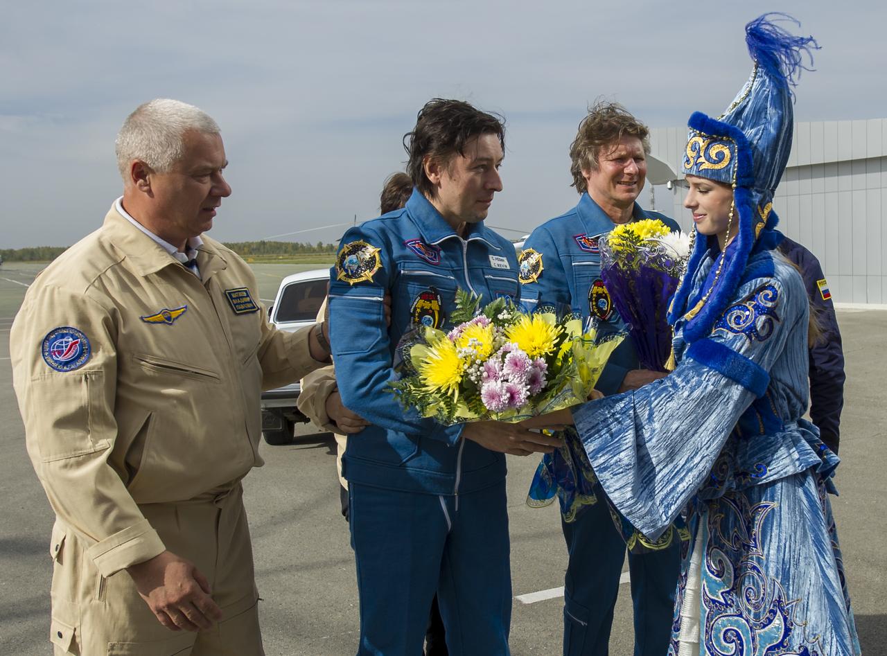 Expedition 32 Russian cosmonaut Sergei Revin, center, is welcomed to Kostanay, Kazakhstan after he and Expedition 32 Commander Gennady Padalka and NASA Flight Engineer Joe Acaba returned from the International Space Station on Monday, Sept. 17, 2012. Revin, Padalka and Padalka returned from five months onboard the International Space Station where they served as members of the Expedition 31 and 32 crews. Photo Credit: (NASA/Carla Cioffi)