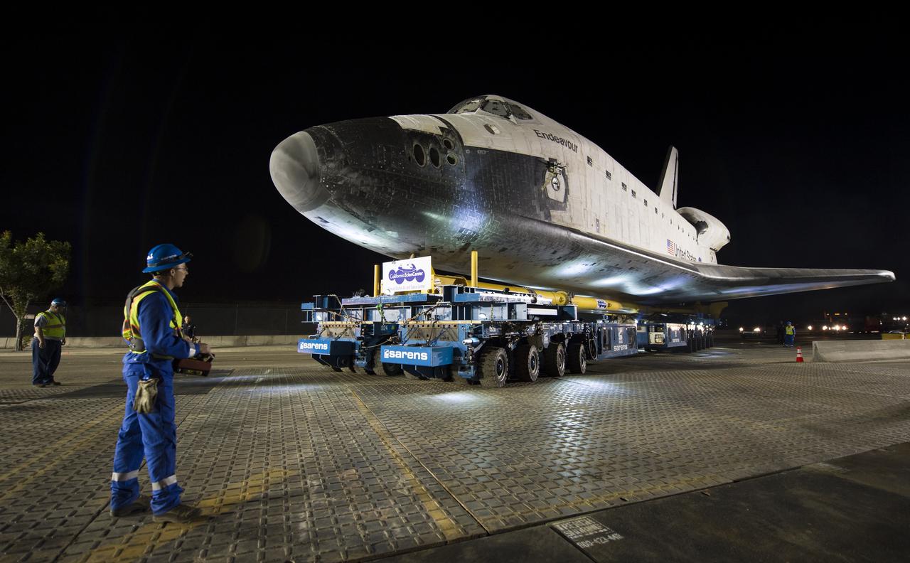 The driver of the Over Land Transporter is seen as he maneuvers the space shuttle Endeavour on the streets of Los Angeles as it heads to its new home at the California Science Center, Friday, Oct. 12, 2012. Endeavour, built as a replacement for space shuttle Challenger, completed 25 missions, spent 299 days in orbit, and orbited Earth 4,671 times while traveling 122,883,151 miles. Beginning Oct. 30, the shuttle will be on display in the CSC’s Samuel Oschin Space Shuttle Endeavour Display Pavilion, embarking on its new mission to commemorate past achievements in space and educate and inspire future generations of explorers. Photo Credit: (NASA/Bill Ingalls)