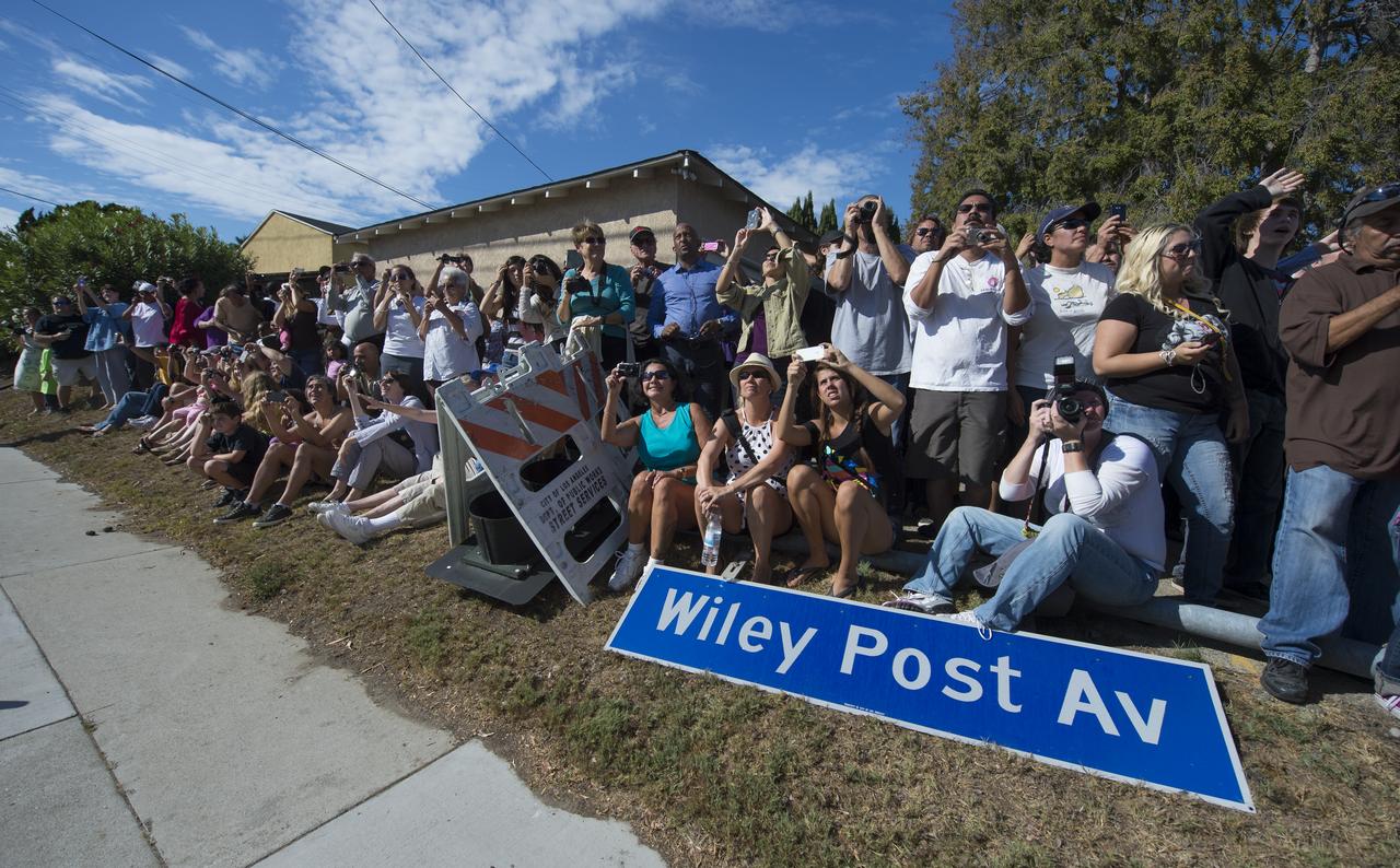 Spectators are seen as they watch space shuttle Endeavour as it passes by on its way to its new home at the California Science Center in Los Angeles, Friday, Oct. 12, 2012.  Endeavour, built as a replacement for space shuttle Challenger, completed 25 missions, spent 299 days in orbit, and orbited Earth 4,671 times while traveling 122,883,151 miles. Beginning Oct. 30, the shuttle will be on display in the CSC’s Samuel Oschin Space Shuttle Endeavour Display Pavilion, embarking on its new mission to commemorate past achievements in space and educate and inspire future generations of explorers. Photo Credit: (NASA/Carla Cioffi)