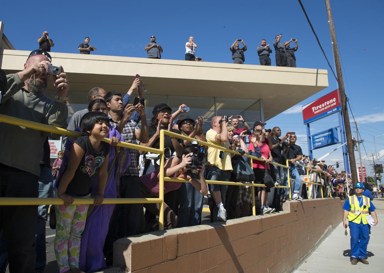 Spectators are seen as they watch space shuttle Endeavour as it passes by on its way to its new home at the California Science Center in Los Angeles, Friday, Oct. 12, 2012.  Endeavour, built as a replacement for space shuttle Challenger, completed 25 missions, spent 299 days in orbit, and orbited Earth 4,671 times while traveling 122,883,151 miles.  Beginning Oct. 30, the shuttle will be on display in the CSC's Samuel Oschin Space Shuttle Endeavour Display Pavilion, embarking on its new mission to commemorate past achievements in space and educate and inspire future generations of explorers.  Photo Credit: (NASA/Carla Cioffi)
