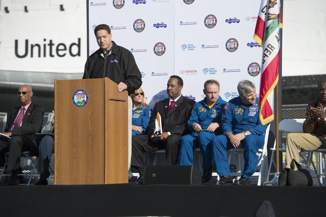 Jeffrey Rudolph, President and CEO, California Science Center speaks at the Endeavour Kick-Off Ceremony at The Forum in Inglewood, Saturday, Oct. 13, 2012. Behind him are seen Hildreth Walker, Founder of A-Man Inc. STEM International Science Center, far left; James T. Butts, Jr., Mayor of Inglewood; NASA astronauts Michael Fincke and Gregory Johnson, far right. Endeavour, built as a replacement for space shuttle Challenger, completed 25 missions, spent 299 days in orbit, and orbited Earth 4,671 times while traveling 122,883,151 miles. Beginning Oct. 30, the shuttle will be on display in the CSC’s Samuel Oschin Space Shuttle Endeavour Display Pavilion, embarking on its new mission to commemorate past achievements in space and educate and inspire future generations of explorers. Photo Credit: (NASA/Carla Cioffi)