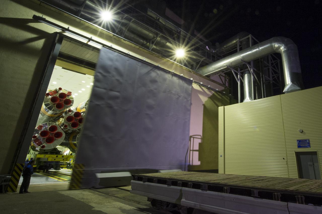 The door of the Soyuz rocket assembly building is opened so that the Soyuz rocket may be rolled out to the launch pad by train, on Sunday, October 21, 2012, at the Baikonur Cosmodrome in Kazakhstan. Launch of the Soyuz rocket is scheduled for October 23 and will send Expedition 33/34 Flight Engineer Kevin Ford of NASA, Soyuz Commander Oleg Novitskiy and Flight Engineer Evgeny Tarelkin of ROSCOSMOS on a five-month mission aboard the International Space Station. Photo Credit: (NASA/Bill Ingalls)