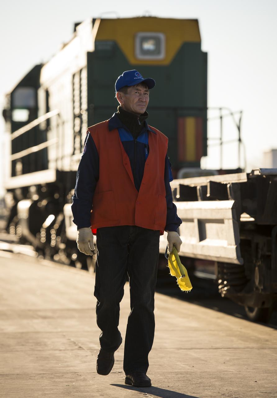 A worker directs a locomotive to that is used to deliver the Soyuz rocket to the launch pad, on Sunday, October 21, 2012, at the Baikonur Cosmodrome in Kazakhstan. Launch of the Soyuz rocket is scheduled for October 23 and will send Expedition 33/34 Flight Engineer Kevin Ford of NASA, Soyuz Commander Oleg Novitskiy and Flight Engineer Evgeny Tarelkin of ROSCOSMOS on a five-month mission aboard the International Space Station. Photo Credit: (NASA/Bill Ingalls)